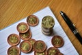 Pile of coins on the wooden table with a golden Czech Crown coin in the value of 20 CZK on the top Royalty Free Stock Photo