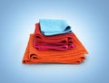 Pile of colored towels isolated on blue gradient background 3d Royalty Free Stock Photo