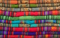 A pile of colorful Andean textiles photographed in the local handicraft market of Cusco