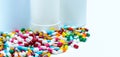 Pile of colorful antibiotic capsule pills on blurred plastic drug bottles. Antibiotic drug resistance concept. Antibiotic drugs Royalty Free Stock Photo