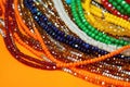 pile of colorful beaded necklaces on an orange surface Royalty Free Stock Photo