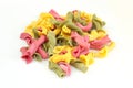 Pile of colorful campanelle pasta isolated on white background. Uncooked raw italian pasta