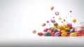 a pile of colorful candies falling into a container on a white background Royalty Free Stock Photo
