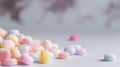 a pile of colorful candies sitting on top of a white table top next to a gray wall with a world map in the background Royalty Free Stock Photo