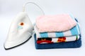 Pile of colorful clothes and electric iron Royalty Free Stock Photo