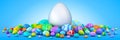 Pile of colorful Easter eggs surrounding a giant white egg Royalty Free Stock Photo