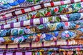 Pile of colorful handwoven Guatemalan blouses called huipiles