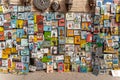 Pile of colorful paintings including famous people's portraits selling on the streets of Marrakech