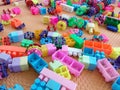 A pile of colorful plastic building blocks scattered on a textured mat. Royalty Free Stock Photo