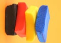 Pile of colorful plasticine blocks on orange background