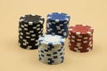 Pile of colorful poker chips on beige background Royalty Free Stock Photo