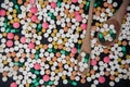 Pile of colorful tablets and capsules pills and wood spoon on bl Royalty Free Stock Photo