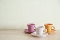 Pile of colorful vintage cups of coffee on wooden table Royalty Free Stock Photo