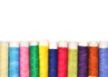 Pile of coloured bobbins of lurex thread isolated on white Royalty Free Stock Photo