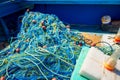 Heap of commercial fishing net on ship`s deck Royalty Free Stock Photo