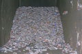 A pile of compacted aluminum cans in a cement compacter in Santa Monica, California