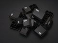 A pile of computer keys on a black background Royalty Free Stock Photo