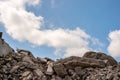 A pile of concrete fragments of a destroyed building against the blue sky. Background