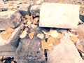 Pile of concrete quadrs with yellow autumn leaves. Material stok