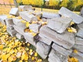 Pile of concrete quadrs with yellow autumn leaves. Material stok