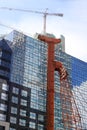 Pile construction crane in site around high rise glass building in Jakarta Indonesia