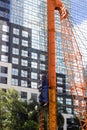 Pile construction crane in site around high rise glass building in Jakarta Indonesia