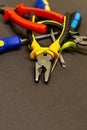 Pile of construction hand tools bright pliers nippers screwdriver on a dark base design base industrial Royalty Free Stock Photo