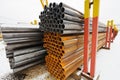 Pile of construction pipes in outdoor warehouse