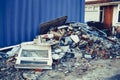 A pile of construction waste near private house. Building rubble, bricks, stones. Junk, garbage piled up near the building. Street