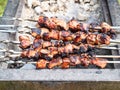 Pile of cooked skewered shish kebabs on brazier