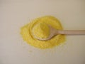 A pile corn semolina on a wooden board