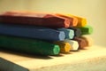 Pile of crayons on a wooden surface