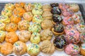Pile of cream puff pastry colorfully decorated with candy sprinkles