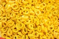 Pile of crispy corn rings close up.