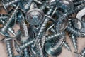 Pile of cross recessed sheetmetal screws, zinc plated, close-up