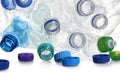 Pile of crumpled bottles and caps on background, closeup. Plastic recycling