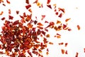 Pile crushed dried red pepper flakes, on white background, top view