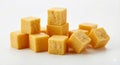 Pile of cut cheddar cheese cubes arranged on a white surface, ready for culinary use or as a snack ingredient Royalty Free Stock Photo
