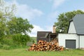 Pile of cut firewood near house on sunny day Royalty Free Stock Photo