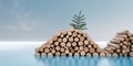 A pile of cut logs on a blue surface A pine tree branch rests atop another pile of logs. Royalty Free Stock Photo