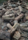 A pile of cut wooden logs, cut down tree trunks sawed and ready for production or to be used as firewood