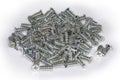 Pile of cylindrical self-threading cross recessed countersunk screws Royalty Free Stock Photo