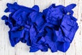 Pile of dark blue nitrile protective gloves on a rustic white background