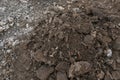 Pile of dark brown construction gardening soil mud land earth dirt heap pile mound