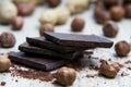 Pile of dark chocolate with nuts and nutshells Royalty Free Stock Photo