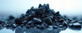 Pile of dark coal chunks rests on reflective surface. Material texture shows rough edges and density. Background is soft light Royalty Free Stock Photo