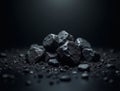 Pile of dark coal rocks on black surface with dramatic lighting Royalty Free Stock Photo