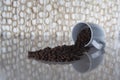 Pile of dark roasted turkish coffee and beans falling out of a white cup Royalty Free Stock Photo