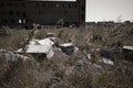 A pile of debris of destroyed building and Abandoned factory building with broken glass windows