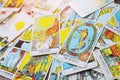 A pile deck of Tarot cards gypsy inspired on a wooden background scattered and haphazardly arranged. Royalty Free Stock Photo